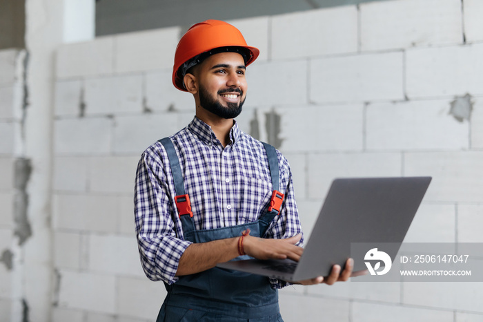 Portrait of architect using laptop against building