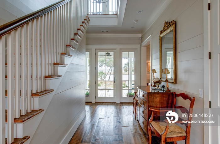 Luxury home entry foyer with view out onto waterfront property.