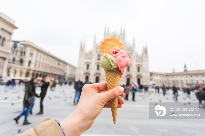 Travel, Italy, gelato and holidays concept - Ice cream in front of Milan Cathedral Duomo