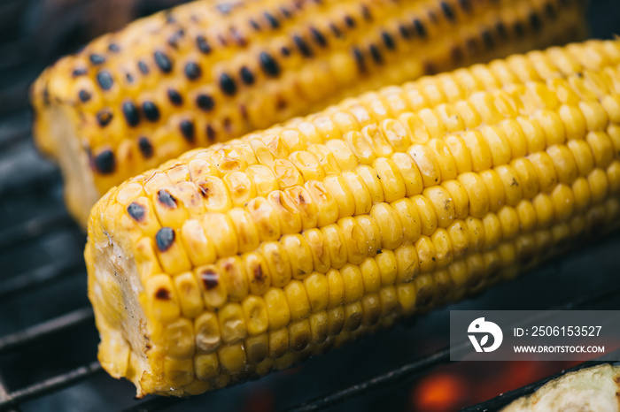 close up of yellow corn with crust grilling on barbecue grid