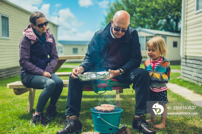 Multigenerational family enjoying barbecue in trailer park