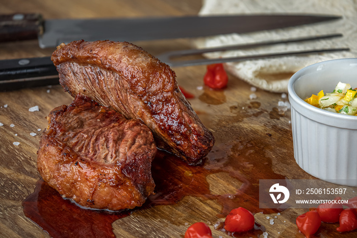 Traditional Brazilian picanha sliced on wooden board.