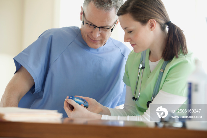 nurse discussing with senior make patient