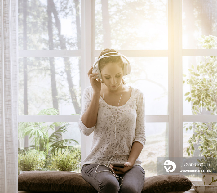 Relaxed woman listening to music at home