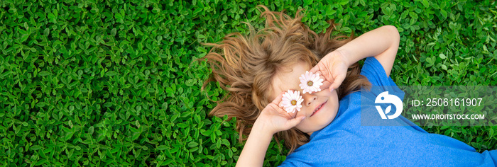 Banner with spring child face. Spring kid. Happy child enjoying on grass field and dreaming. Funny l