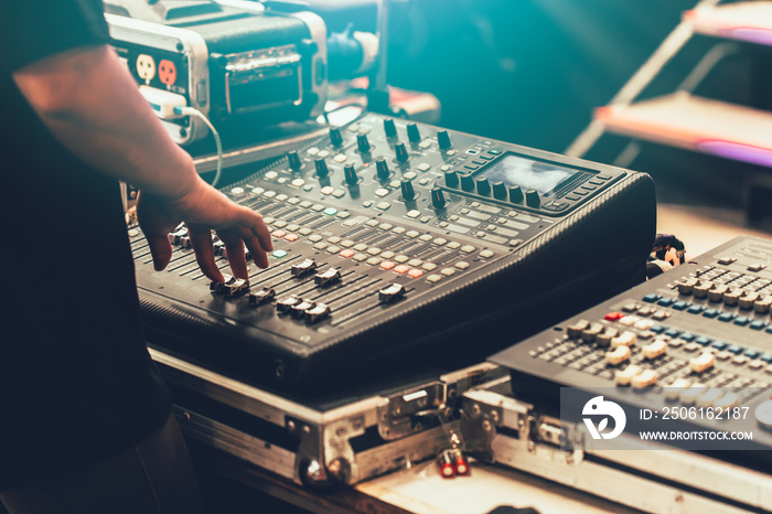 professional stage sound mixer closeup at sound engineer hand using audio mix slider working during 