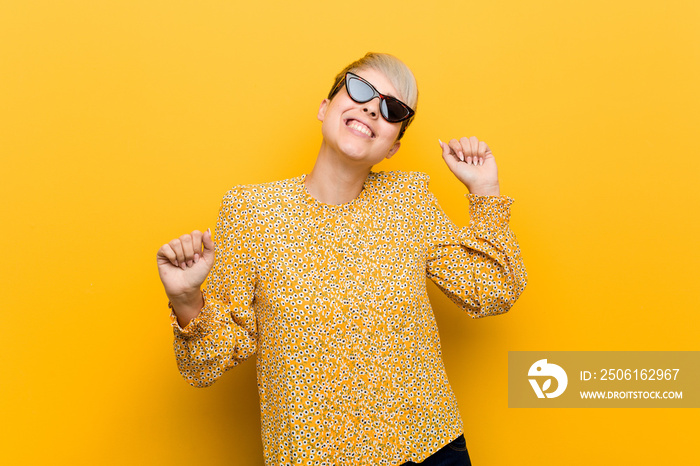 Young curvy woman wearing a floral summer clothes dancing and having fun.