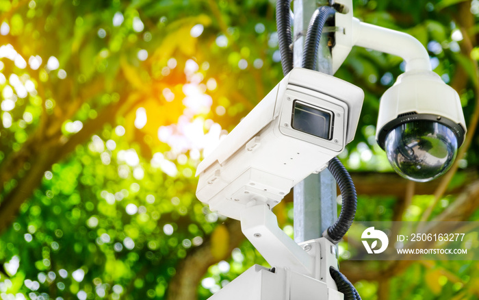 Modern public CCTV camera on a electric pole with blurred natural background. Intelligent reccording