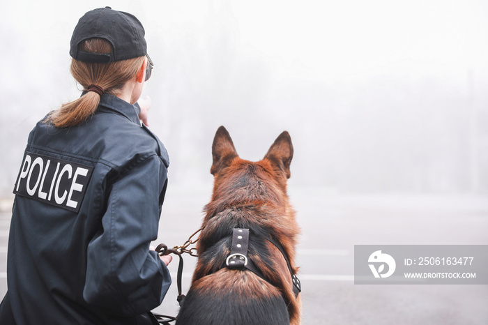 带狗的女警察在城市街道巡逻