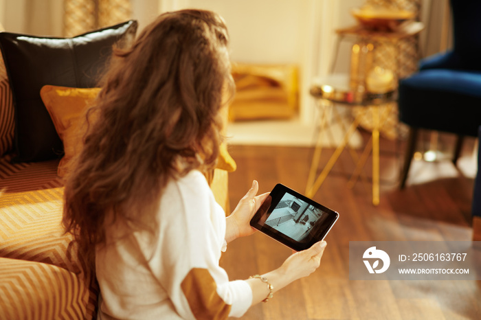 fit woman watching video from security camera on tablet PC