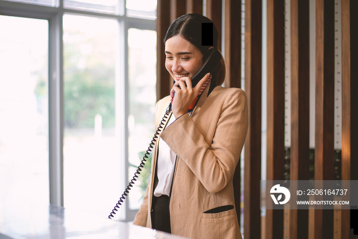 The hotel receptionist was answering a phone call to provide information to customers.