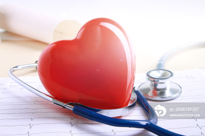 Red heart and a stethoscope on desk