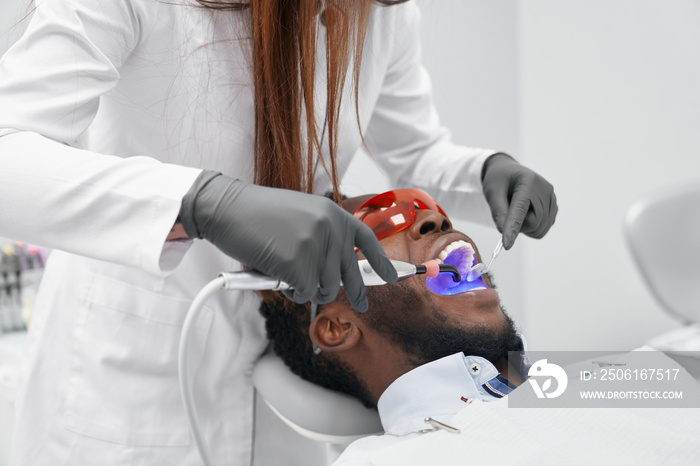 View from side of female doctor in process of doing filling