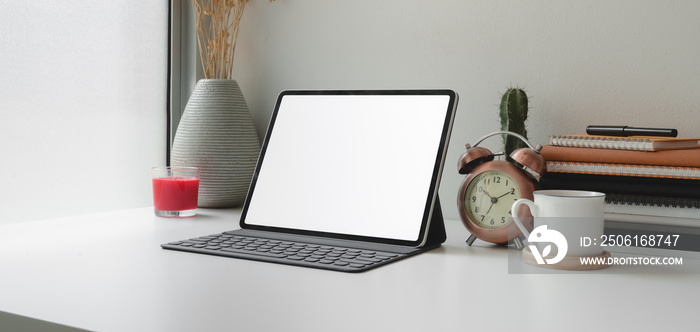 Contemporary workplace with blank screen digital tablet and office supplies