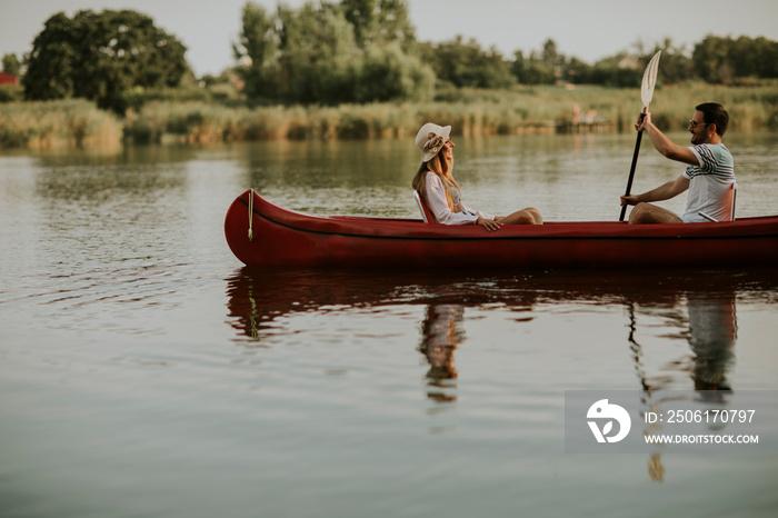 Loving couple rowing on the lake