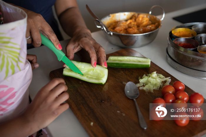 UK, London,�Close-up�of mother and daughter cooking in kitchen