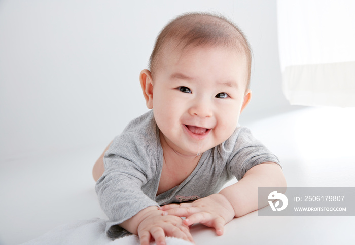 Closeup Asian baby lying on the clean ground