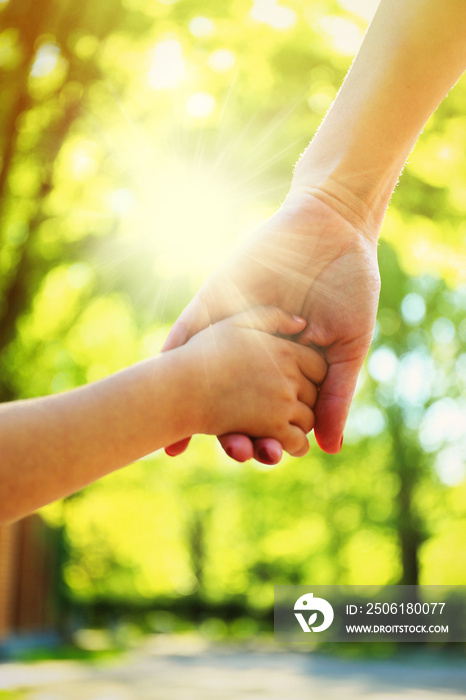 Hands of mother and daughter holding each other