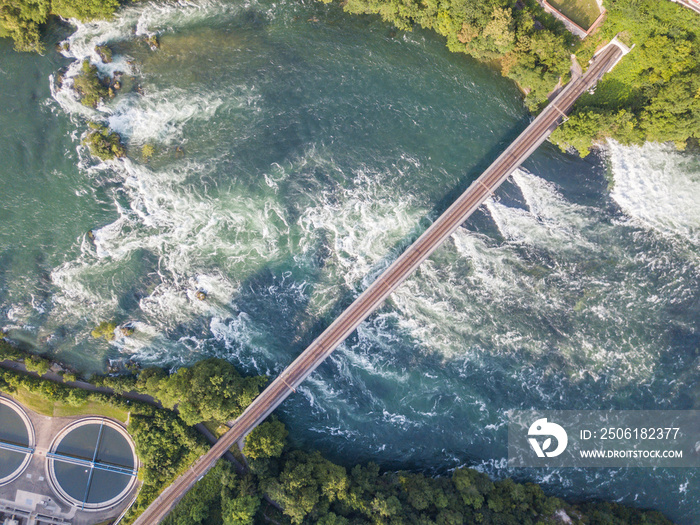 Aerial view of railway bridge with one track across rhine river in Switzerland.