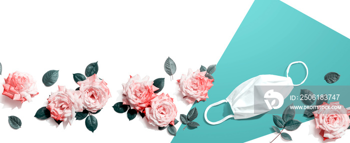 Face mask with pink roses overhead view - flat lay