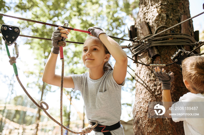 Little kids climbs in rope park, playground