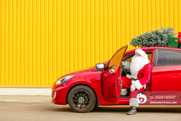 Santa Claus with modern car outdoors