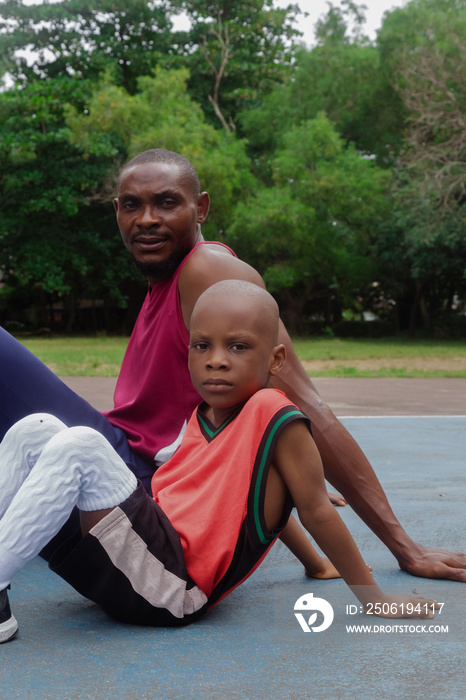 Portrait of father and son at the basketball court