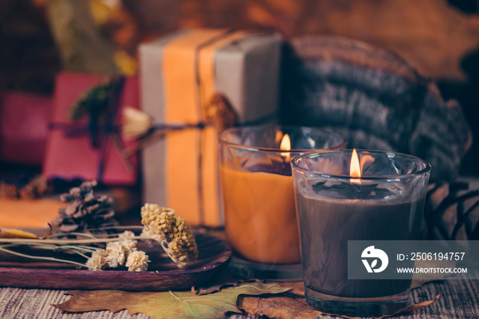 Scented Candles, Presents, Dried Flowers and Leaf Decoration on a Table