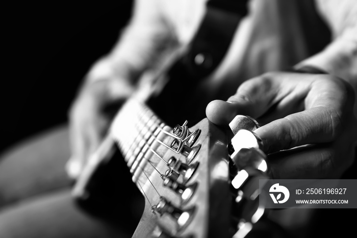 Black and white photo of man with guitar, closeup