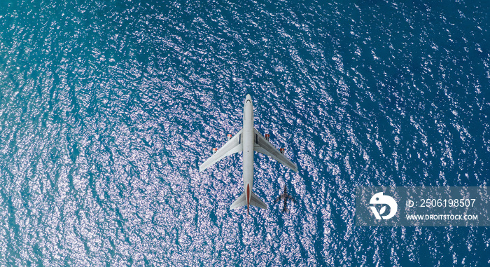 Aerial top view of Airplane flies over a sea, view from above