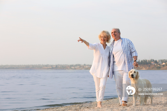 Senior couple and big dog on riverside