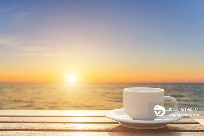 Coffee cup on wood table at sunset or sunrise time