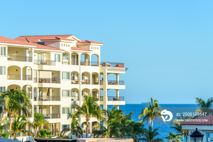 White building with tropical background in Mexico.