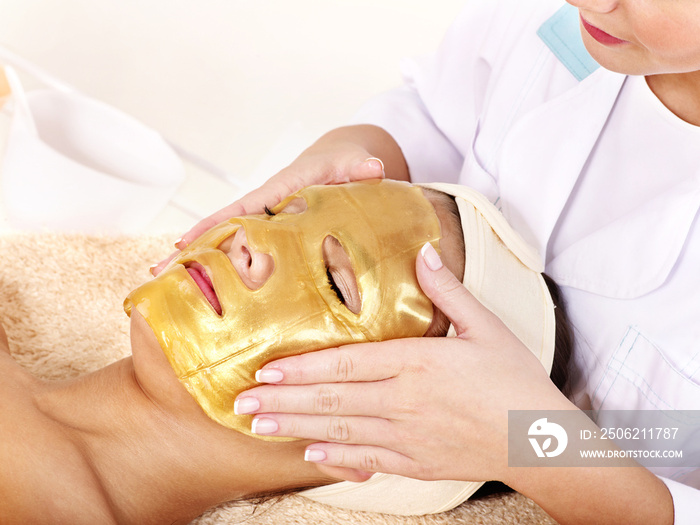 Girl with gold facial mask.