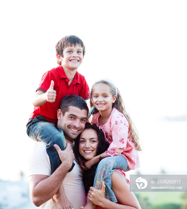 Parents giving children piggyback rides