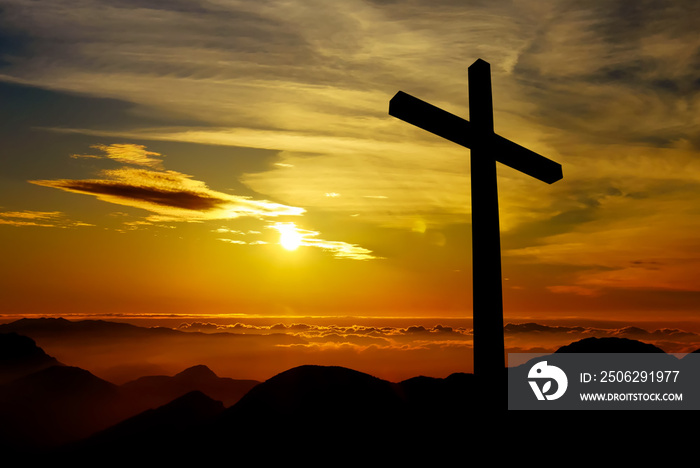 Christian cross on sunset background