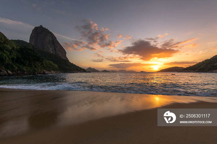 Beautiful Sunrise in the Beach with Few Clouds in the Sky, Sugarloaf Mountain in the Horizon, and Re