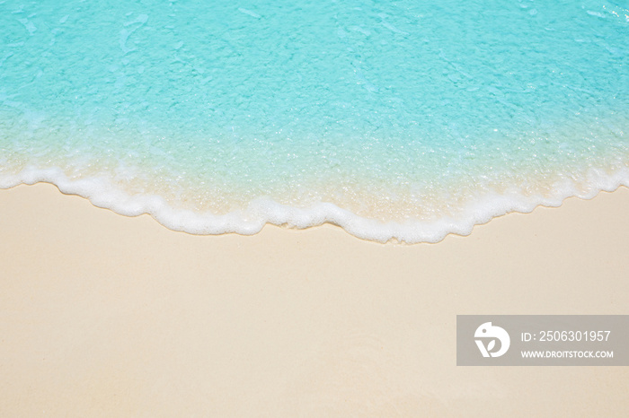 Soft waves of blue sea on the Maldives beach for the background.