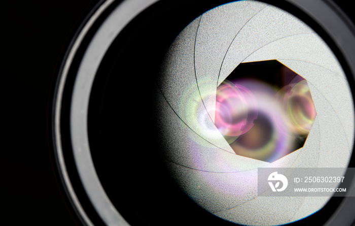 The diaphragm of the aperture of a camera lens. Selective focus with shallow depth of field. Color i