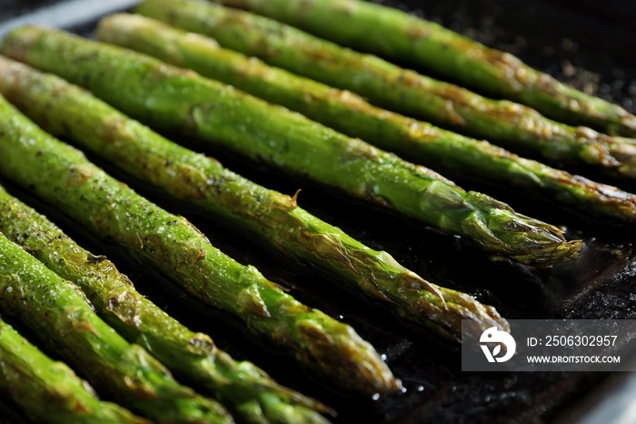 Roasted asparagus on pan, close-up