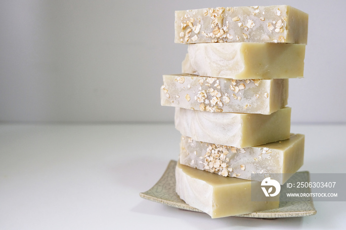 Natural oatmeal soap is placed on a white background.