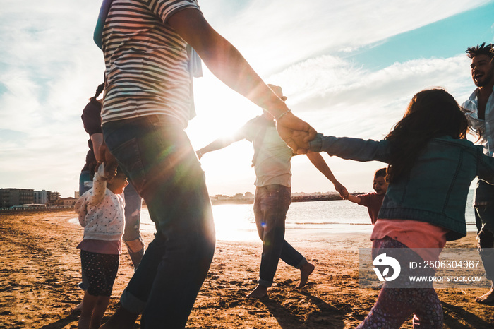 Families playing with children on the beach - Focus on center man feet