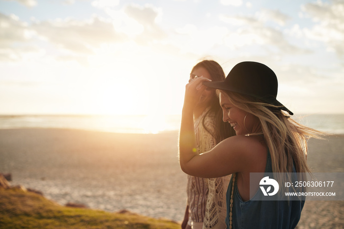 Female friends walking on the sea shore