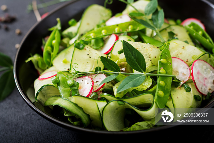 Fresh salad of cucumbers, radishes, green peas and herbs