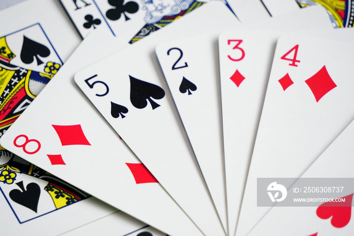 Assorted play cards and combinations on isolated white background close up view