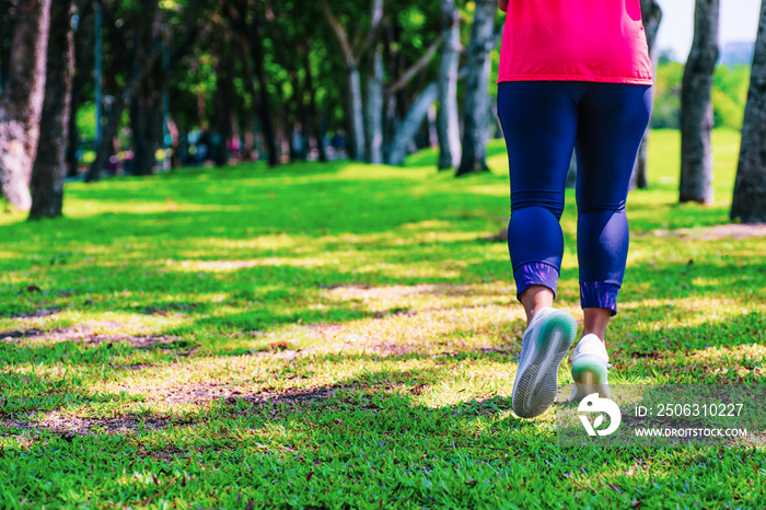 Healthy lifestyle woman runner jogging on beautiful summer day in the public green park. Fitness and