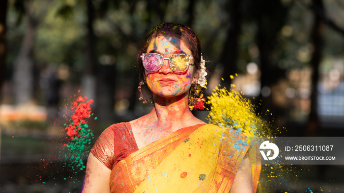 Holi festival of color, Splashing dry organic color or colour or gulal or abeer or Holi powder on a 