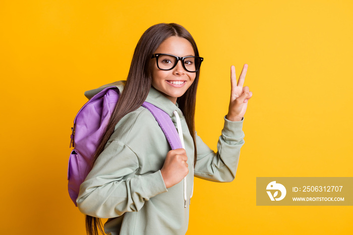 Profile photo of girl with bag show v-sign hello symbol goes learn wear hoodie isolated on yellow co