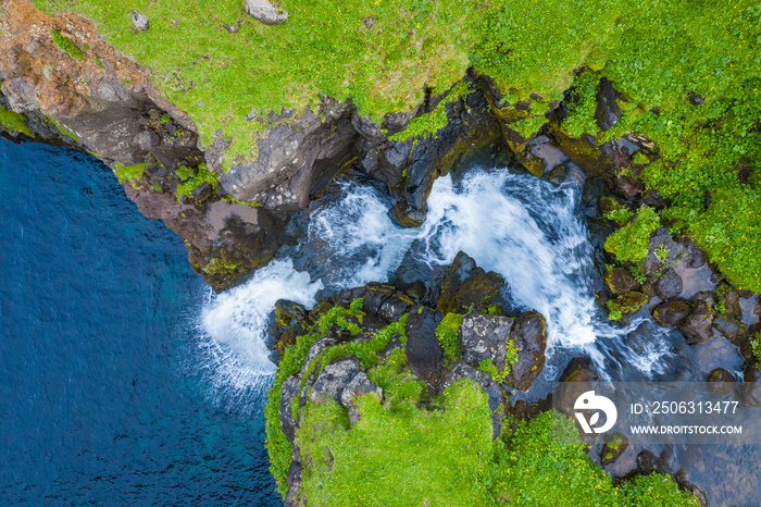 Aerial view of Mulafossur waterfall in Gasadalur village in Faroe Islands, North Atlantic Ocean. Pho