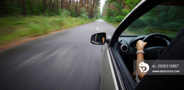 Young beautiful woman driving car - rear view